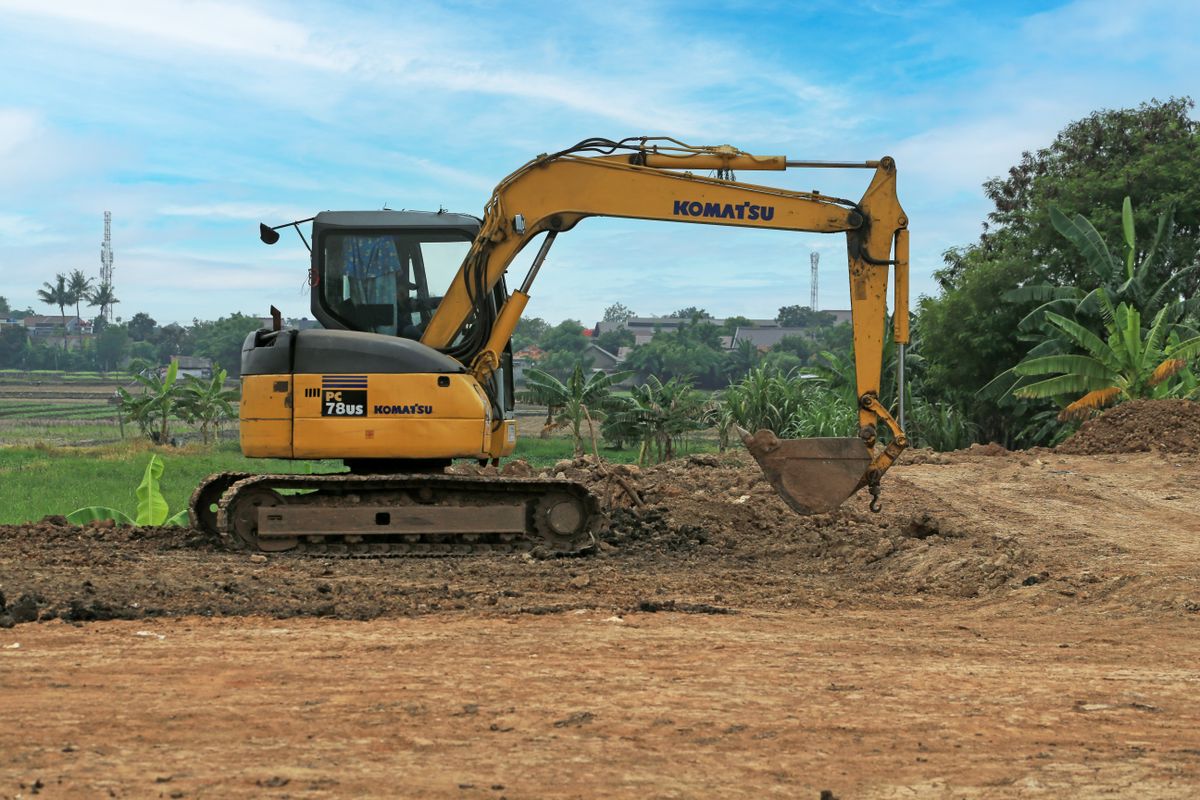 Mini excavator grading a site in Metro Vancouver
